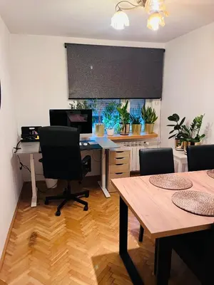 an office with a desk with chairs and a computer at Biały Lotos in Kraków