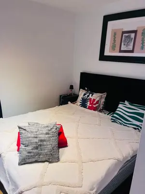 a bed with two pillows on top of it at Biały Lotos in Kraków