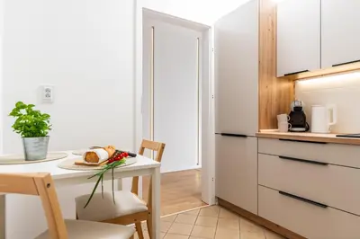 a kitchen with a table with a plate of food on it at Vistula Suite l A Lovely Place to Be in Kraków
