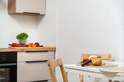 a kitchen with a table with a plate of food on it at Vistula Suite l A Lovely Place to Be in Kraków