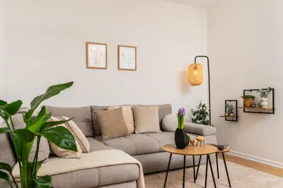 a living room with a couch and a table at Vistula Suite l A Lovely Place to Be in Kraków