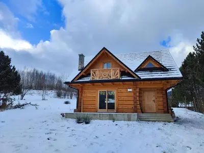 a small house with a roof on top of it at zDrzewaDom in Skrzydlna