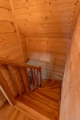 a bedroom with two beds and a window in a cabin at zDrzewaDom in Skrzydlna