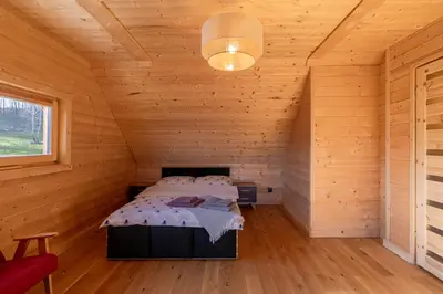 a room with a table and two chairs in a cabin at zDrzewaDom in Skrzydlna