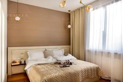 a bedroom with a large bed with a window at Fragola Apartments Kleparz modern family apartments in Kraków