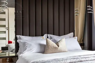 a bedroom with a bed with white pillows at Fragola Apartments Kleparz modern family apartments in Kraków