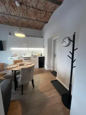 a kitchen and dining room with a table in a room at Villa la Olive Premium Apartaments-Luxury Standard in Oświęcim