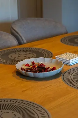 a plate of food on a wooden table at Villa la Olive Premium Apartaments-Luxury Standard in Oświęcim