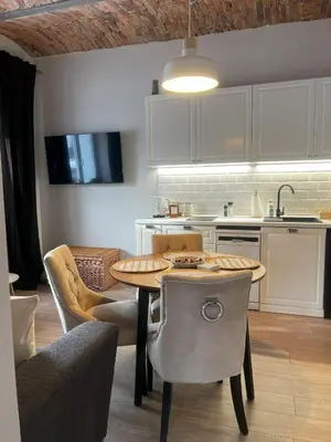 a kitchen with a table and chairs in a kitchen at Villa la Olive Premium Apartaments-Luxury Standard in Oświęcim