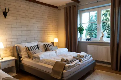 a bedroom with a bed with towels on it at Villa la Olive Premium Apartaments-Luxury Standard in Oświęcim