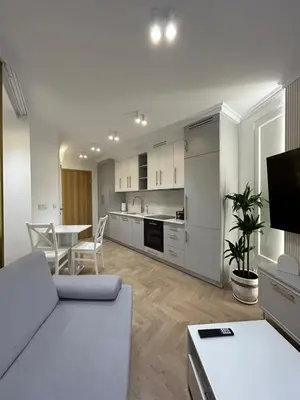 a living room with a couch and a table at Krakow Center Stare Podgorze in Kraków