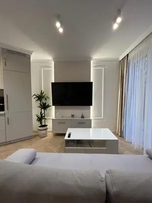 a living room with a couch and a flat screen tv at Krakow Center Stare Podgorze in Kraków