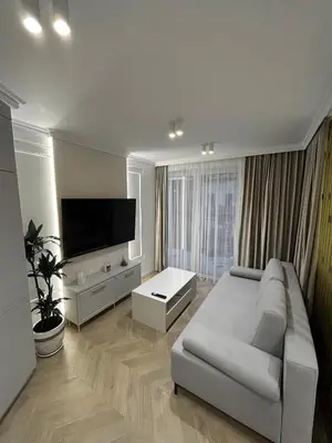 a living room with a couch and a flat screen tv at Krakow Center Stare Podgorze in Kraków