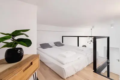 a bedroom with a bed and a potted plant at Nowoczesny Apartament w Centrum Krakowa by Noclegi Renters in Kraków