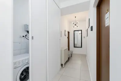 a laundry room with a washer and dryer at Nowoczesny Apartament w Centrum Krakowa by Noclegi Renters in Kraków