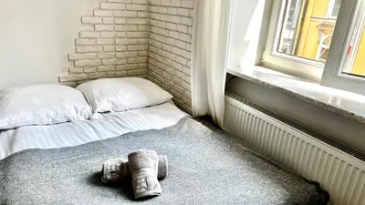 a living room with a couch and a table at Cinema Apartment with a view of Old Town in Kraków