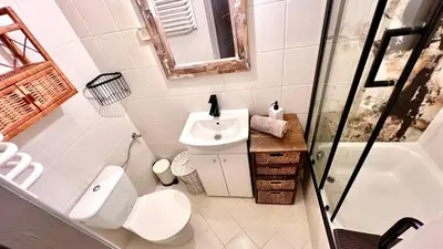 a bed in a room with a window at Cinema Apartment with a view of Old Town in Kraków