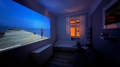 a bathroom with a large poster of a man and a woman at Cinema Apartment with a view of Old Town in Kraków