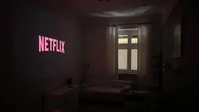 a living room with a white couch in a dark room at Cinema Apartment with a view of Old Town in Kraków
