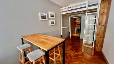 a small room with a bed and a window at Cinema Apartment with a view of Old Town in Kraków