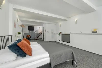 a bedroom with a bed with orange and blue pillows at Apartament Przyszłości z dwiema sypialniami w Krakowie by Noclegi Renters in Kraków