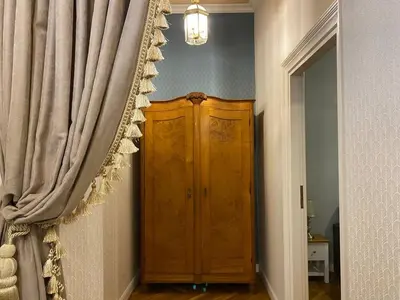 a room with a wooden cabinet and a curtain at Radiance Residence Apartments in Kraków