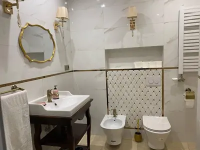 a bathroom with a sink and a toilet and a mirror at Radiance Residence Apartments in Kraków