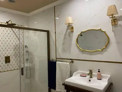 a bathroom with a sink and a shower and a mirror at Radiance Residence Apartments in Kraków