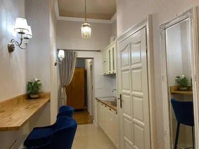a small kitchen with blue chairs and a sink at Radiance Residence Apartments in Kraków