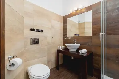 a bathroom with a toilet and a sink and a shower at Asnyka Wyjątkowy Apartament w Centrum Krakowa by Noclegi Renters in Kraków