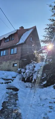 a house with snow in front of it at SOWIA CHATKA- Stryszawa - domek z jacuzzi in Stryszawa