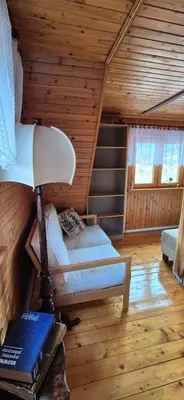 a room with a bed and a lamp in a cabin at SOWIA CHATKA- Stryszawa - domek z jacuzzi in Stryszawa