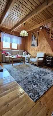 a living room with a couch and a table at SOWIA CHATKA- Stryszawa - domek z jacuzzi in Stryszawa