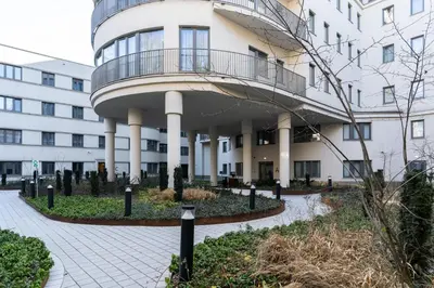 a white building with a balcony on top of it at Cracow Superior Apartment by BookingHost in Kraków
