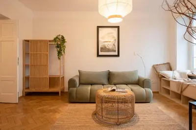 a living room with a couch and a table at Riverside Harmony in Kraków