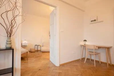 a living room with a table and a chair at Riverside Harmony in Kraków