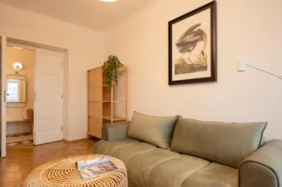a living room with a couch and a table at Riverside Harmony in Kraków