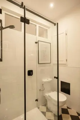 a bathroom with a toilet and a glass shower door at Riverside Harmony in Kraków