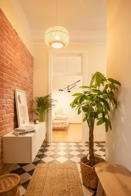 a living room with a potted plant on a checkered floor at Riverside Harmony in Kraków