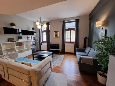 a living room with a couch and a table at DaVinci Bello apartment in Kraków