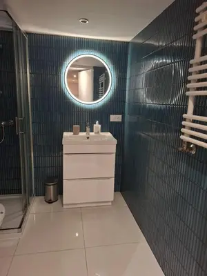 a bathroom with a sink and a mirror at DaVinci Bello apartment in Kraków