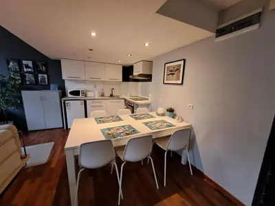 a kitchen and dining room with a table and chairs at DaVinci Bello apartment in Kraków