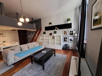 a living room with a couch and a loft at DaVinci Bello apartment in Kraków
