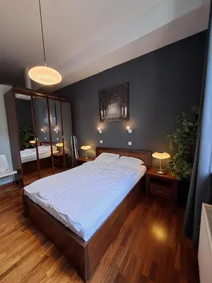 a bedroom with a large bed with white sheets at DaVinci Bello apartment in Kraków