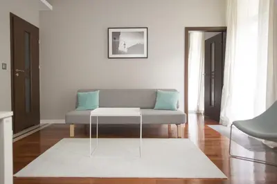 a living room with a couch and a table at Pastel Apartment in Kraków