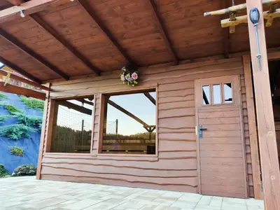 a wooden garage with a door and a window at Agroturystyka Faron in Rozdziele
