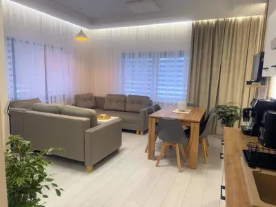 a living room with a couch and a table at Domek za rzeką 2 in Zawoja