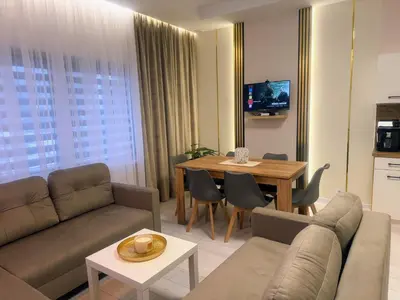 a living room with a couch and a table at Domek za rzeką 2 in Zawoja