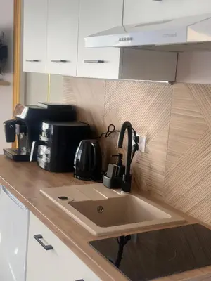 a kitchen counter with a sink in a kitchen at Domek za rzeką 2 in Zawoja