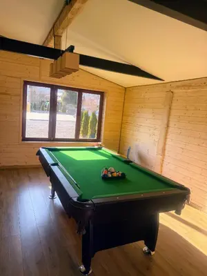 a room with a pool table in a room at Domek za rzeką 2 in Zawoja